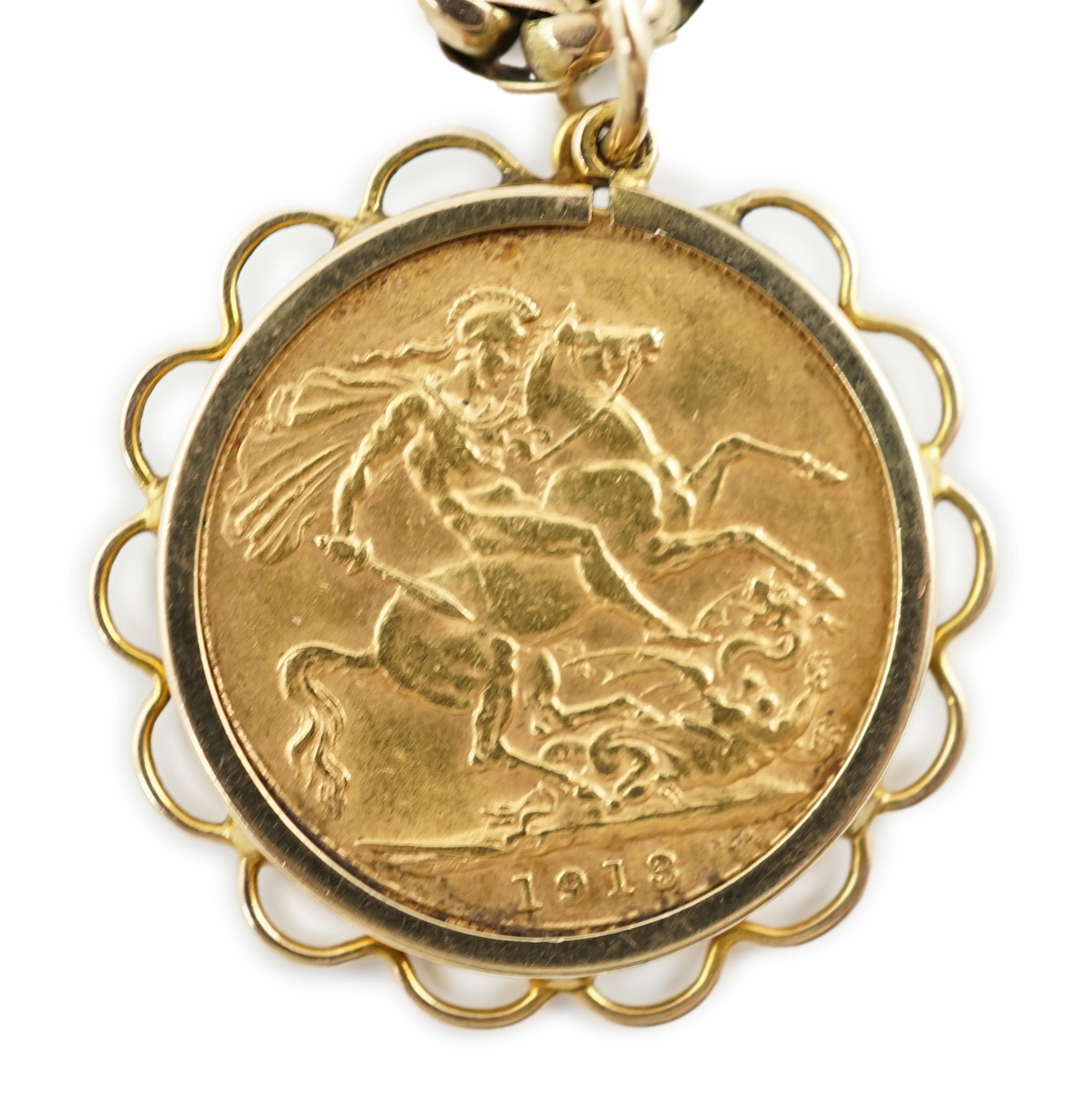 A George V gold sovereign, in a later 9ct gold pendant mount, on a 9ct chain